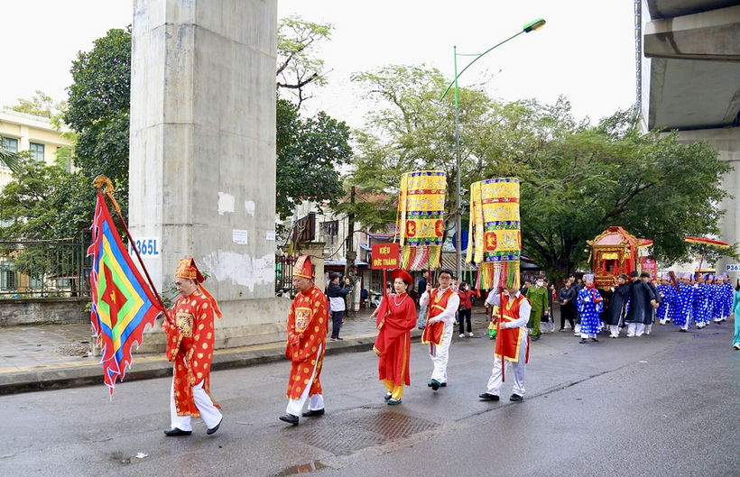 A group of people in red and white uniforms marching down a street
Description automatically generated with low confidence