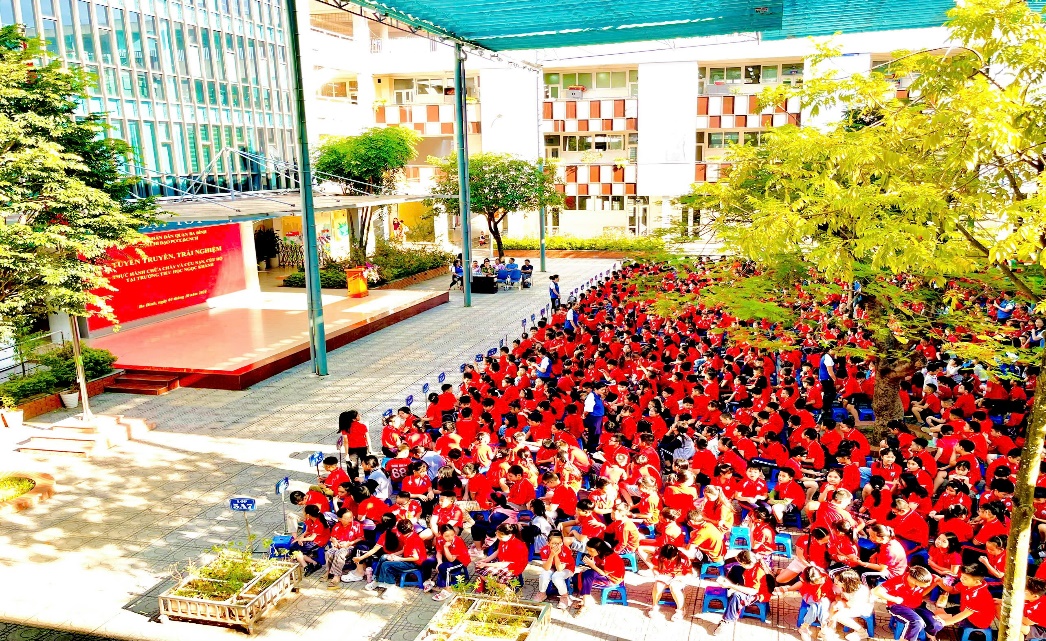 A group of people in red shirts
Description automatically generated