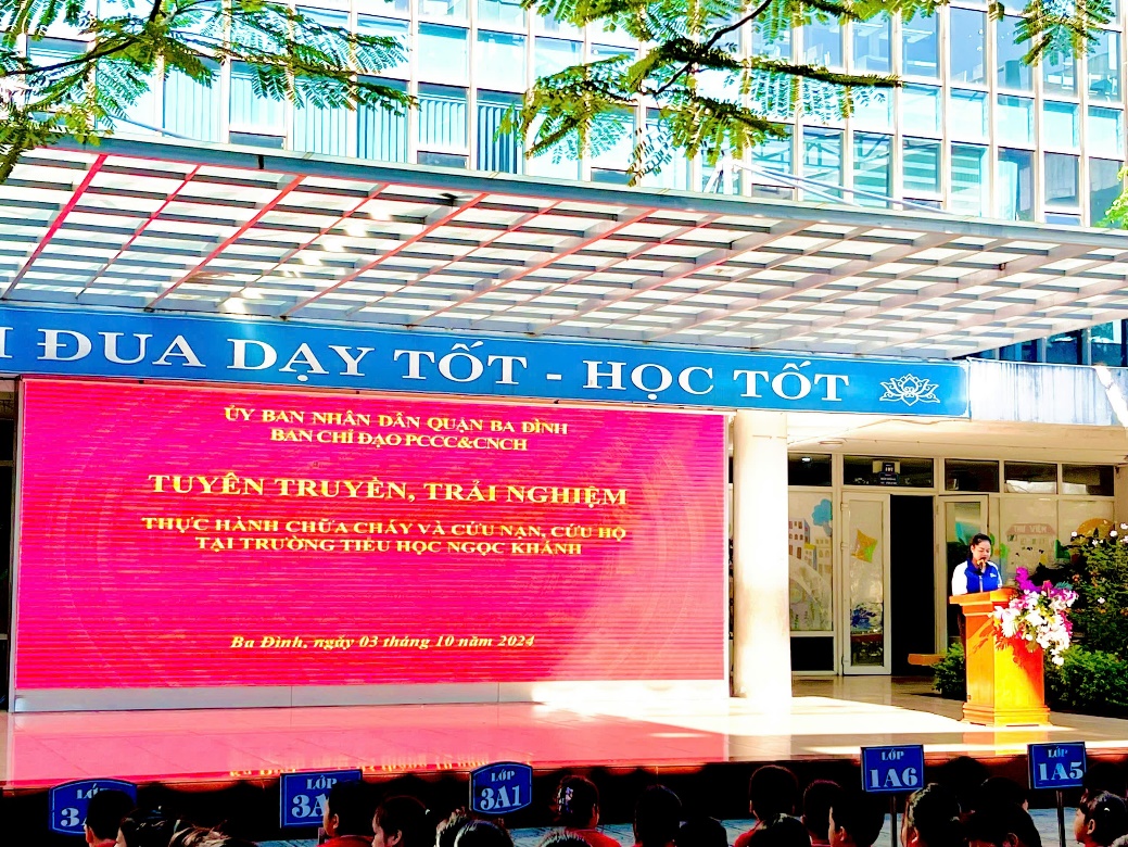 A person standing in front of a large screen
Description automatically generated