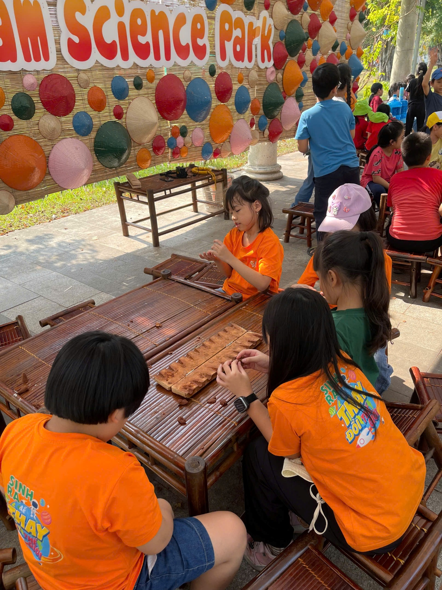 A group of children playing with sticks

Description automatically generated