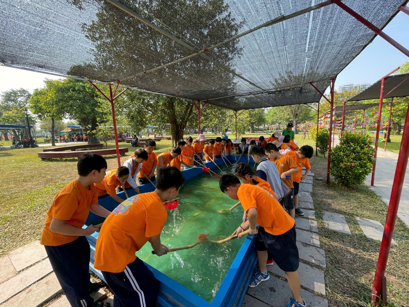 A group of people in orange shirts

Description automatically generated