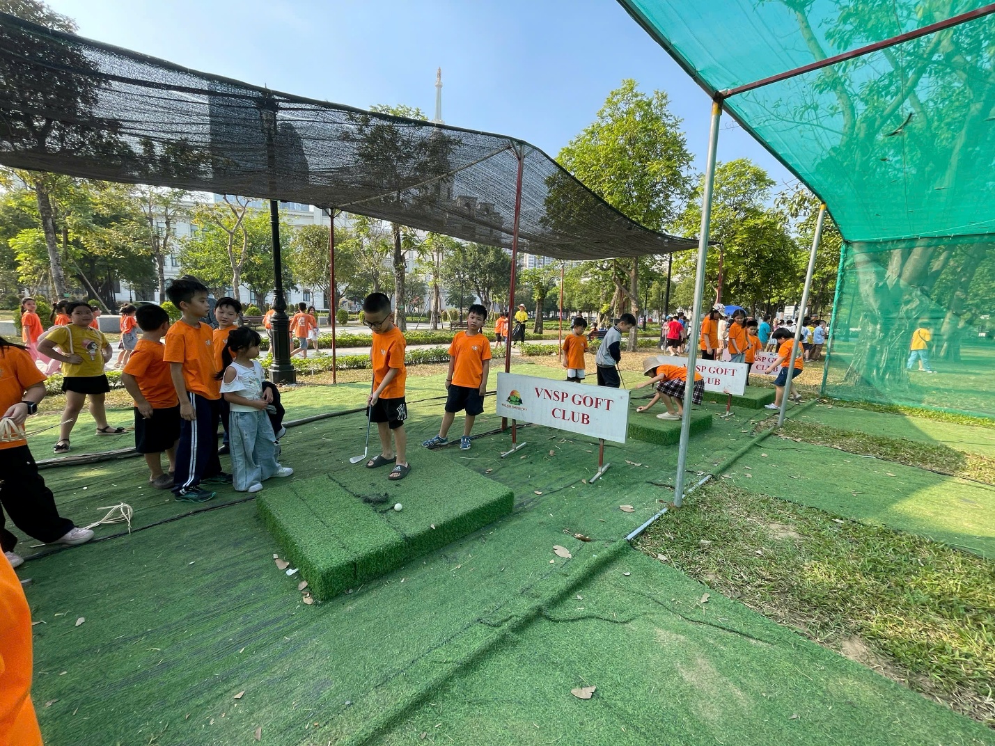 A group of kids standing in a field

Description automatically generated
