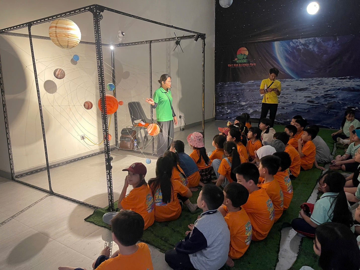 A group of children sitting on the floor

Description automatically generated