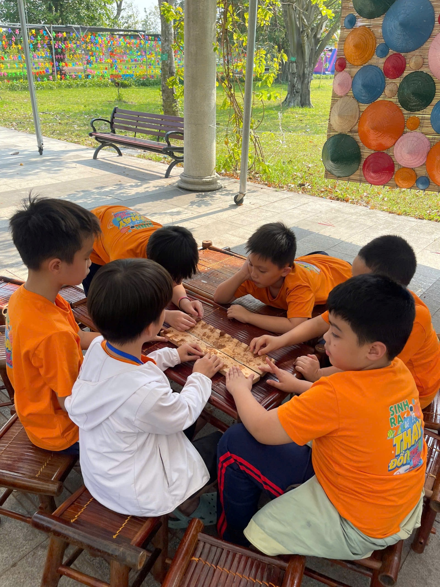 A group of boys playing a board game

Description automatically generated