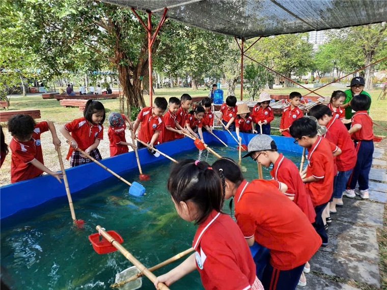A group of children in red shirts

Description automatically generated