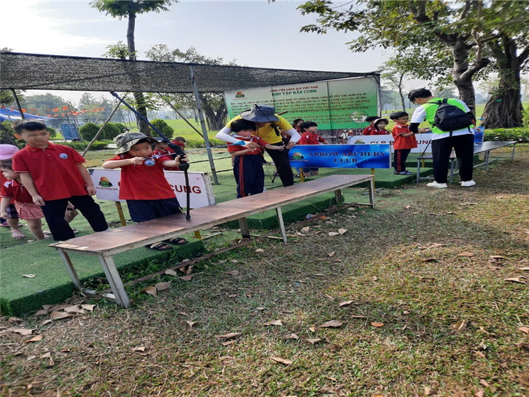 A group of kids standing on a bench

Description automatically generated
