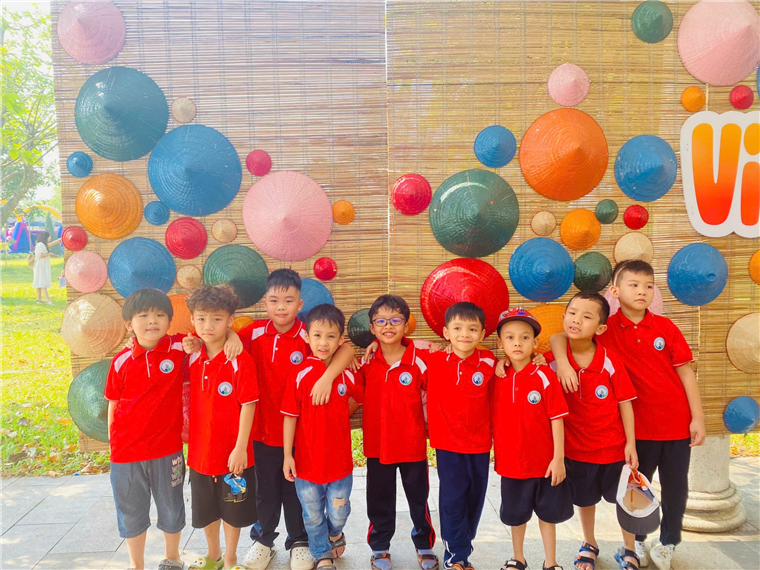 A group of kids in red shirts

Description automatically generated