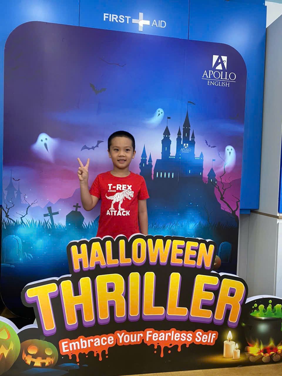 A child standing in front of a sign
Description automatically generated