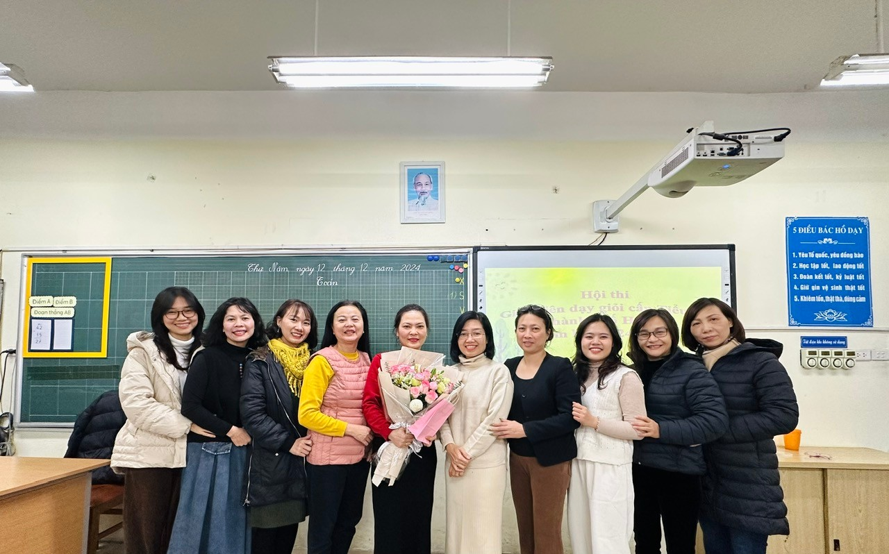 A group of women standing in a classroom
Description automatically generated