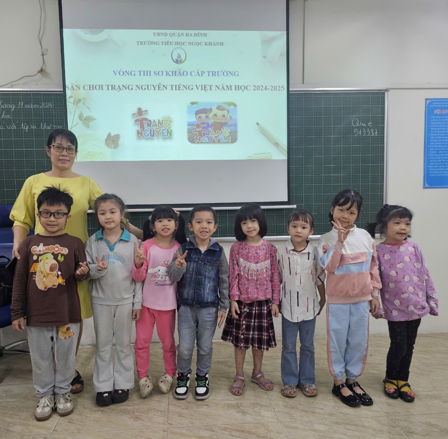 A group of children standing in front of a chalkboard

Description automatically generated