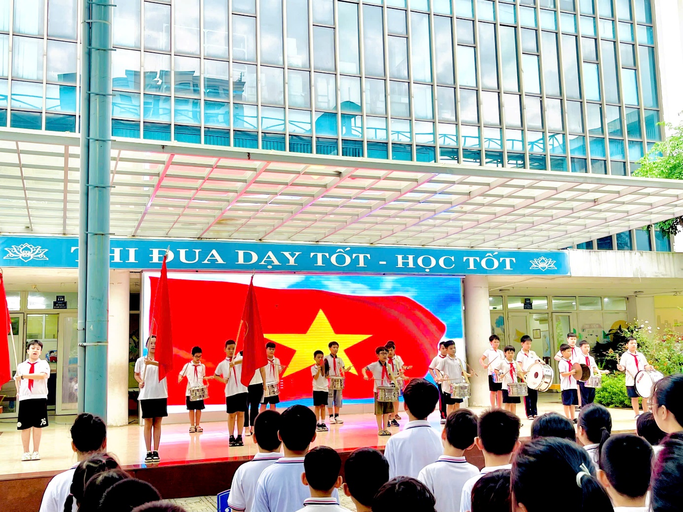 A group of people in uniform performing on stage

Description automatically generated