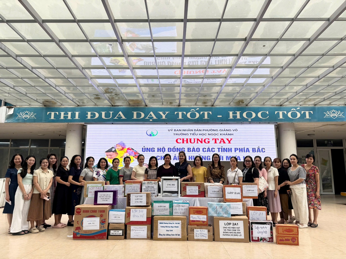 A group of people standing in front of a large sign

AI-generated content may be incorrect.