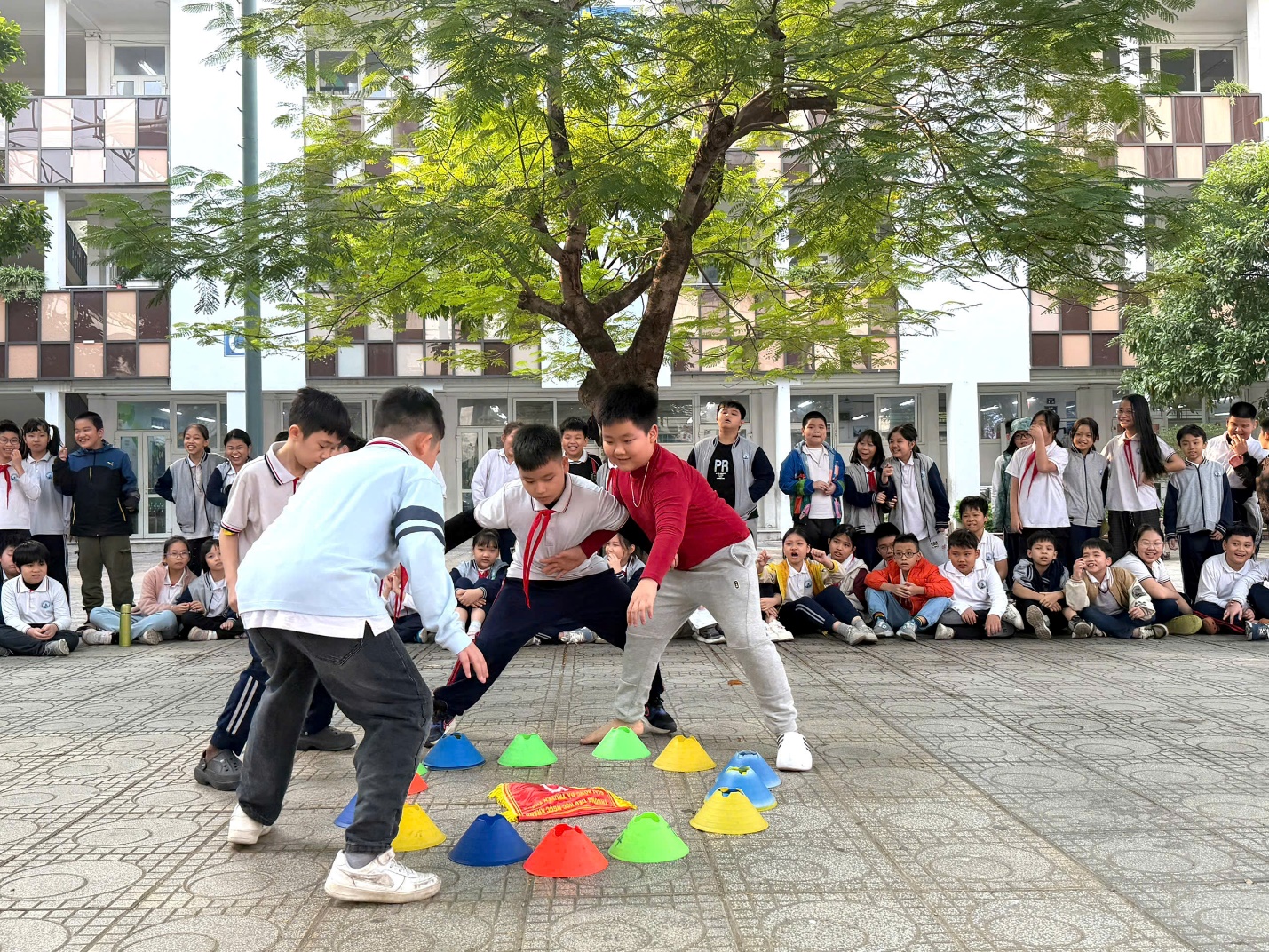 A group of kids playing with colorful cones
AI-generated content may be incorrect.