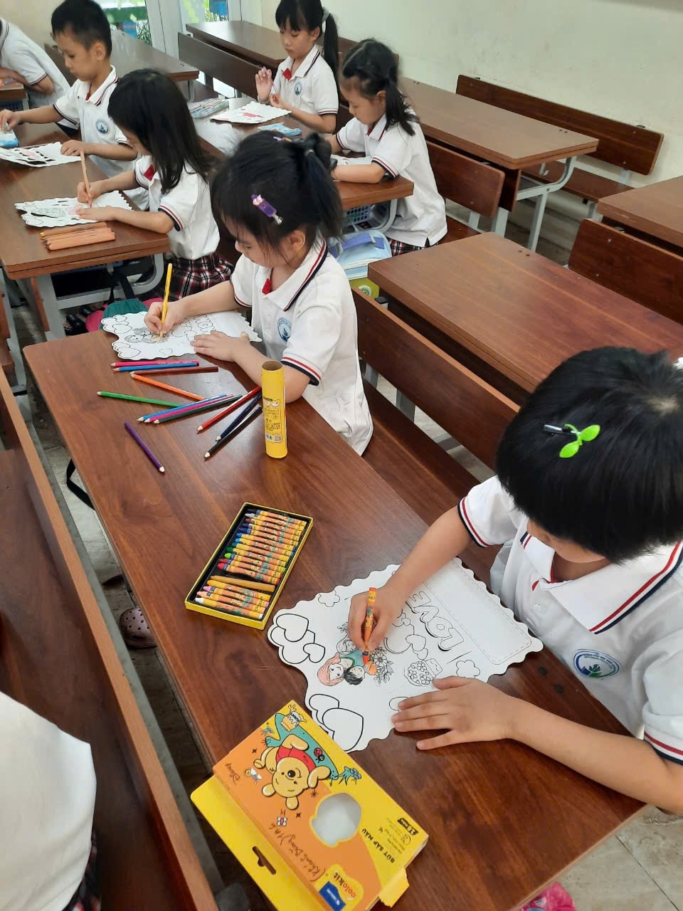 A group of children sitting at desks in a classroom

AI-generated content may be incorrect.