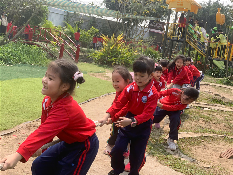 A group of children playing tug of war

Description automatically generated