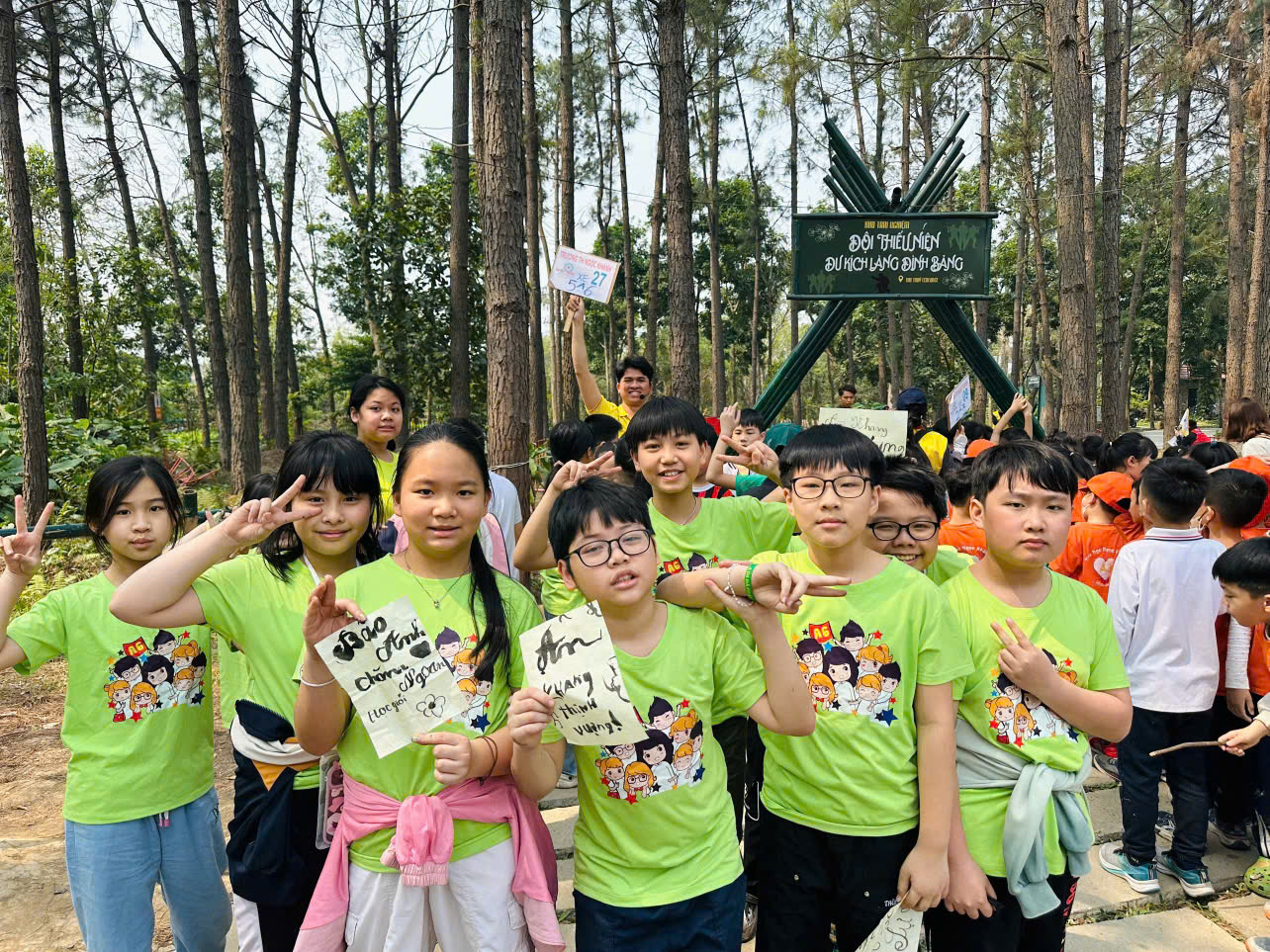 A group of children in green shirts

AI-generated content may be incorrect.