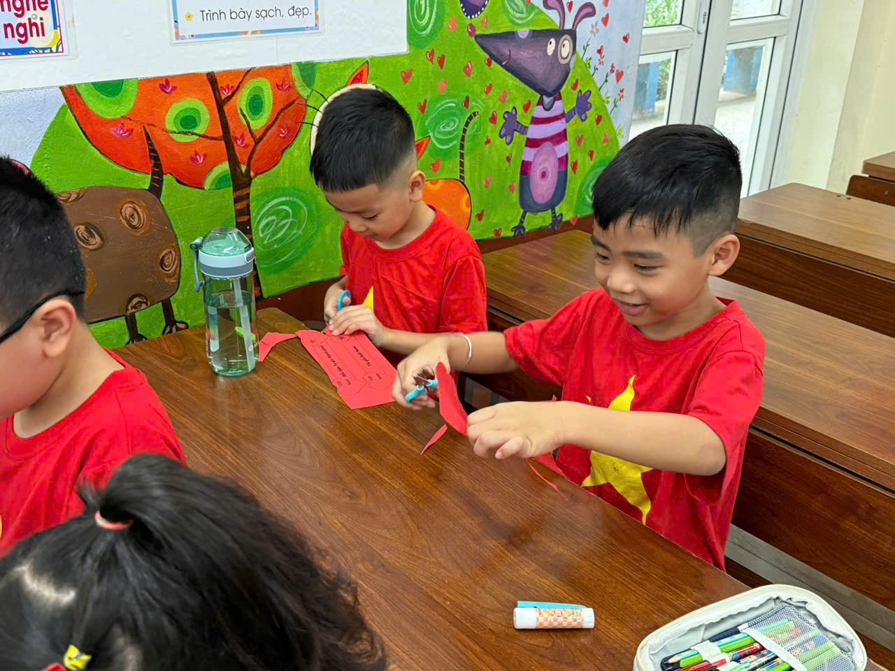 A group of children sitting at a table

AI-generated content may be incorrect.