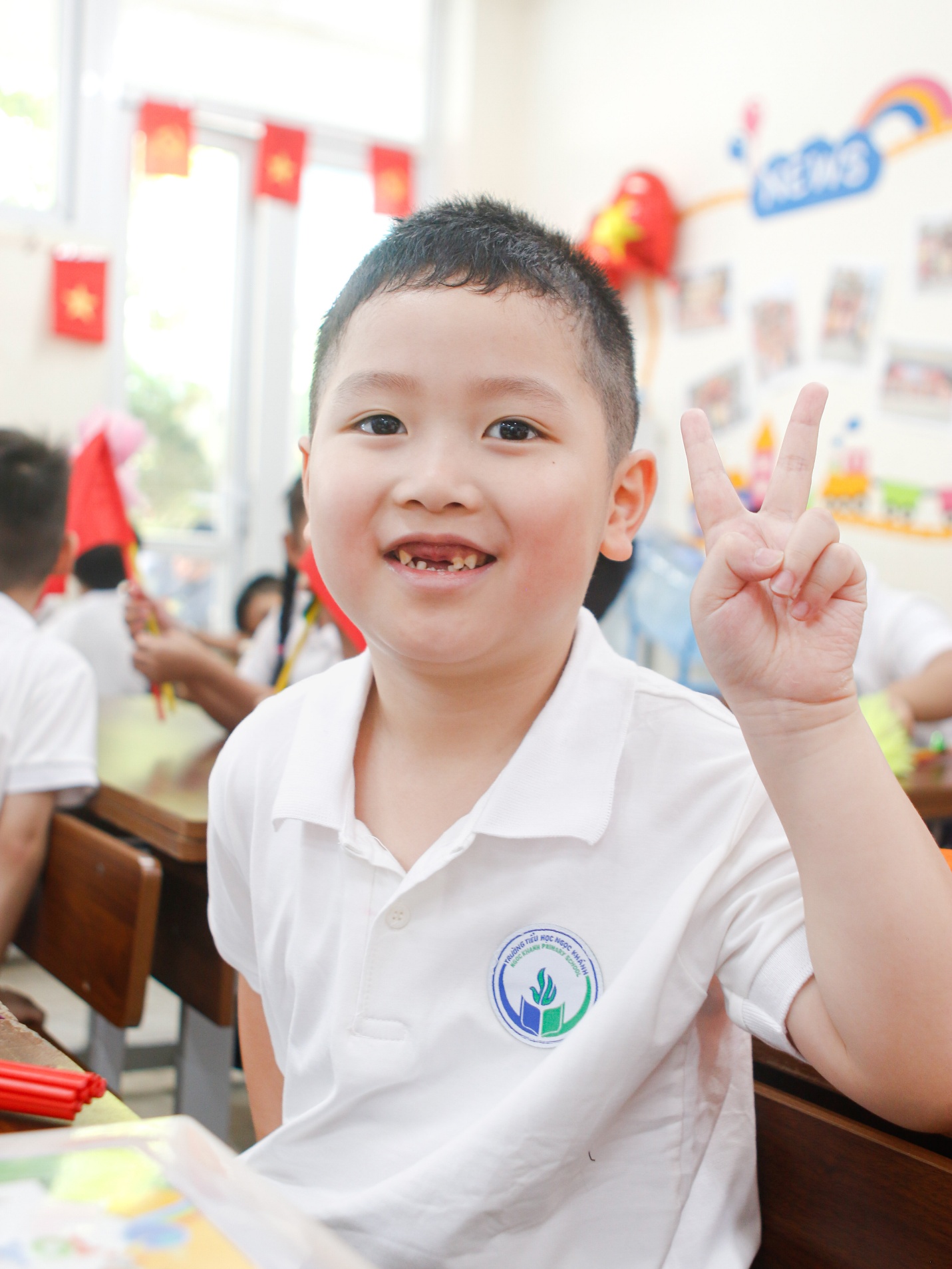 A child in a classroom holding up a peace sign

AI-generated content may be incorrect.