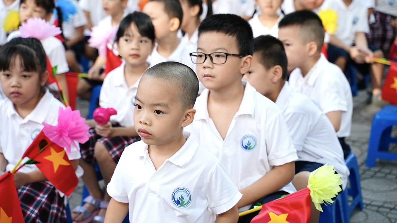 A group of children in white shirts

Description automatically generated