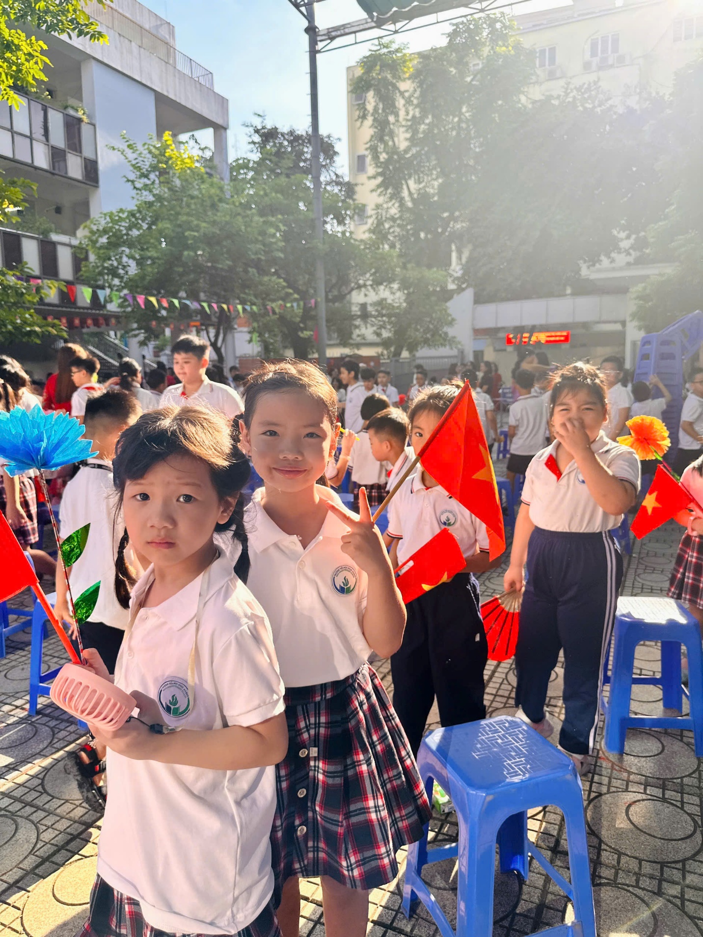 A group of children holding flags
Description automatically generated